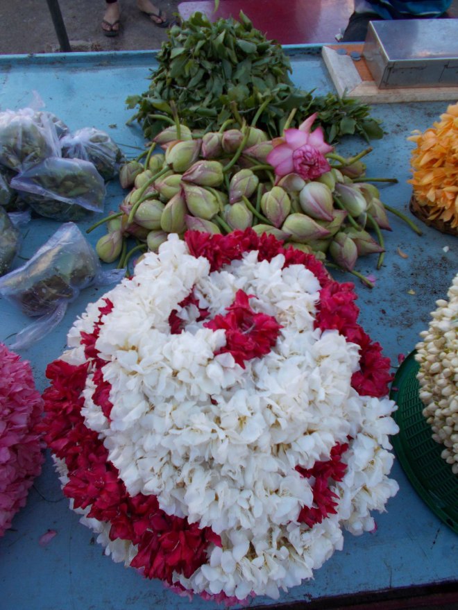 Garlands of flowers and lotuses for sale outside the temple 